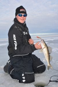 Jake Romanack lifting his walleye from ice hole